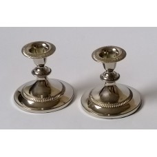  Two small, artistic, metal candlesticks