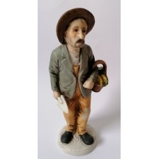 Ceramic statuette of a elderly man with a spade and a bag